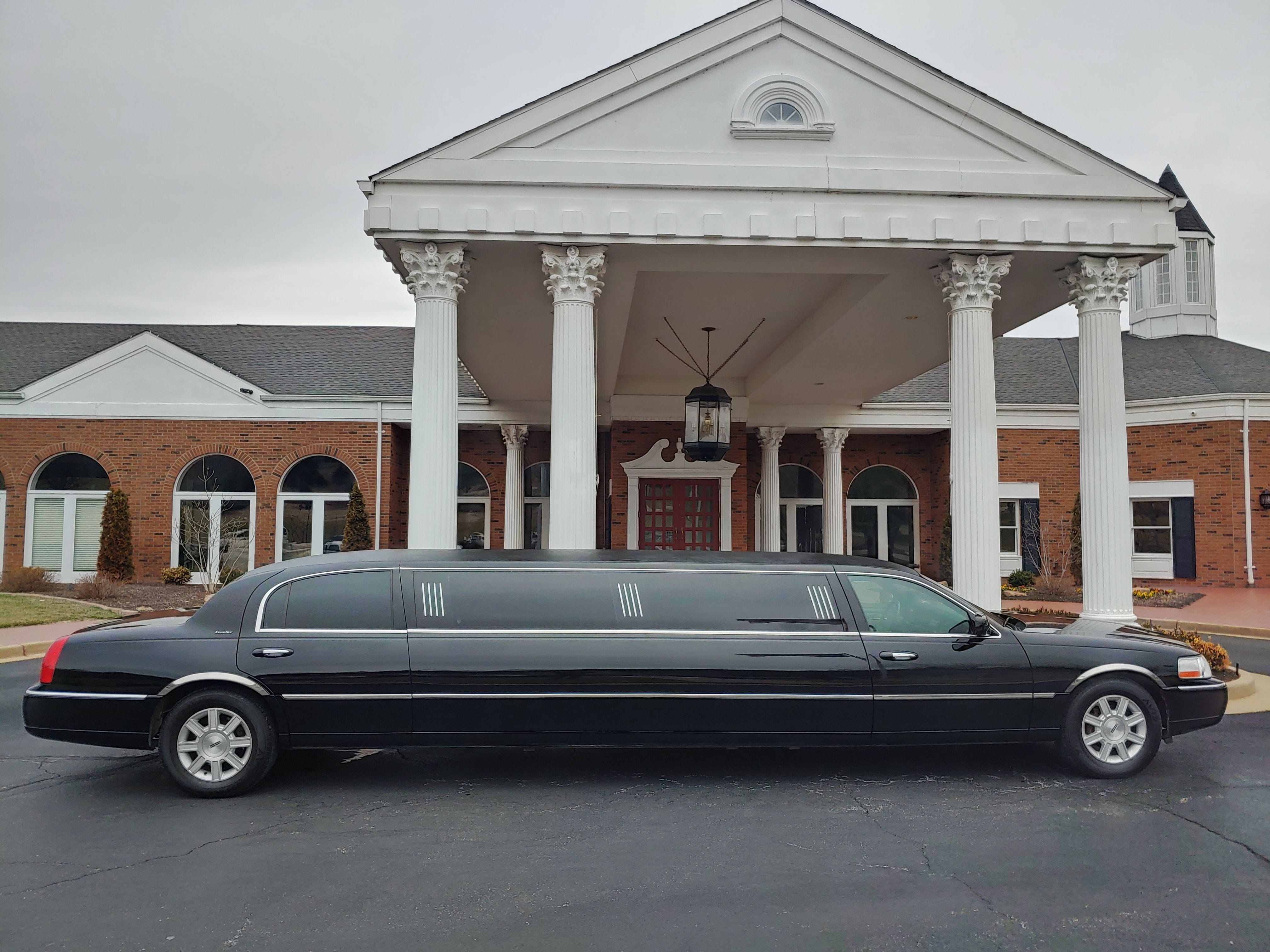 Black Lincoln Limousine in front of office